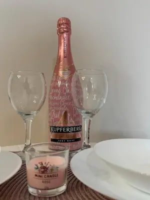 a bottle of wine and two wine glasses on a table at Kutak mira in Belgrade