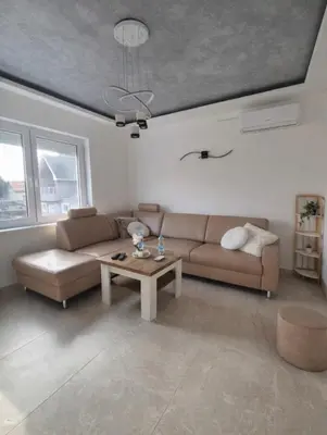 a living room with a couch and a coffee table at AeroLux Apartments-Surčin, Near Belgrade Airport in Surčin