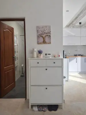 a white dresser in a room with a kitchen at AeroLux Apartments-Surčin, Near Belgrade Airport in Surčin