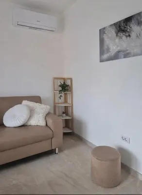 a living room with a couch and a stool at AeroLux Apartments-Surčin, Near Belgrade Airport in Surčin