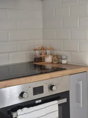a kitchen with a counter top with a stove at AeroLux Apartments-Surčin, Near Belgrade Airport in Surčin
