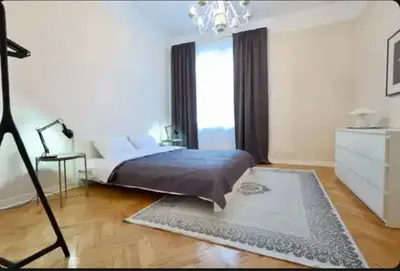 a bedroom with a bed and a chandelier at Central Harmony Apartments in Belgrade
