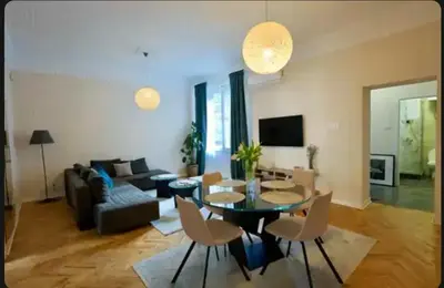 a living room with a couch and a table and chairs at Central Harmony Apartments in Belgrade