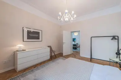 a bedroom with a bed and a dresser and a mirror at Central Harmony Apartments 1 in Belgrade