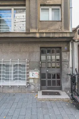 a building with a door and a bike parked outside at Central Harmony Apartments 1 in Belgrade
