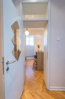 an open door leading into a kitchen with a table at Central Harmony Apartments 2 in Belgrade