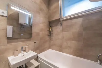 a bathroom with a sink and a bath tub at Central Harmony Apartments 2 in Belgrade