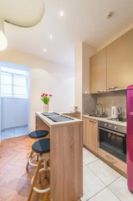 a kitchen with a counter with stools and a stove at Central Harmony Apartments 2 in Belgrade