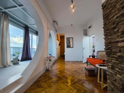 a living room with a stone wall and a couch at apartment on top of the city in Belgrade