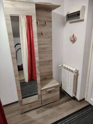 a dressing room with a mirror and a red curtain at Elena Airport Apartments in Surčin