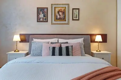 a bedroom with a bed with pillows and two lamps at Ambasador&Luxury Downtown apartment in Belgrade