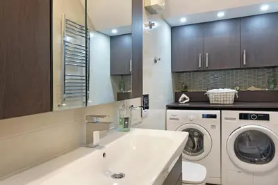 a bathroom with a sink and a washing machine at Ambasador&Luxury Downtown apartment in Belgrade
