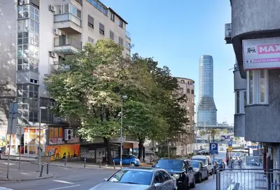 a busy city street with cars parked on the street at Ambasador&Luxury Downtown apartment in Belgrade