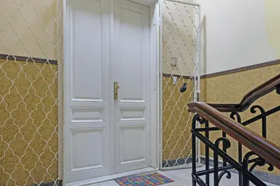 a white door in a room with a staircase at Ambasador&Luxury Downtown apartment in Belgrade