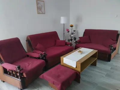 a living room with two red couches and a coffee table at Aleksej in Irig