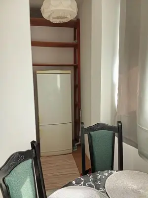 a room with two chairs and a door leading to a kitchen at Aleksej in Irig
