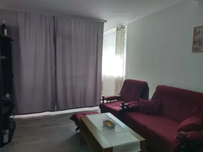 a living room with a red couch and a coffee table at Aleksej in Irig
