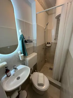 a bathroom with a sink and a toilet and a shower at SKY NEST - Small Studio, Grand View in Belgrade