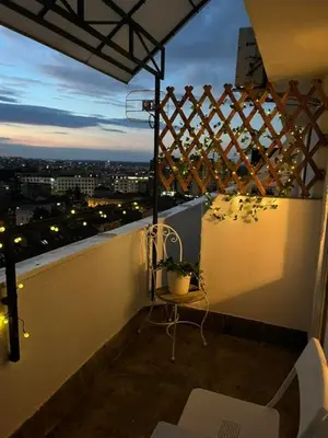 a balcony with a view of a city at night at SKY NEST - Small Studio, Grand View in Belgrade