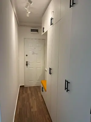 a hallway with white cabinets and a white door at SKY NEST - Small Studio, Grand View in Belgrade