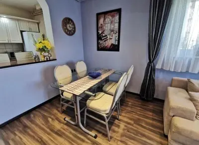 a dining room table and chairs in a living room at Vila Miona Apartments in Belgrade