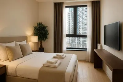 a bedroom with a bed and a tv and a window at Belgrade Waterfront - River Residences in Belgrade