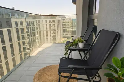 a balcony with two chairs and a table with plants at Belgrade Waterfront - River Residences in Belgrade