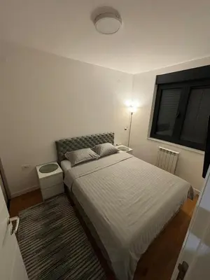 a small bedroom with a bed and a window at Lux Star Belgrade in Belgrade