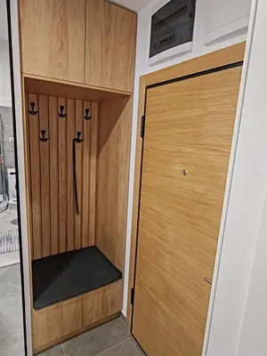 a closet with wooden doors in a room at Lux Star Belgrade in Belgrade
