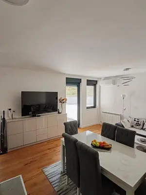 a living room with a table and a couch at Lux Star Belgrade in Belgrade