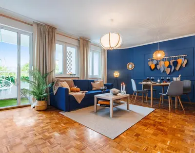 a blue living room with a blue couch and a table at Indigo Spirit with Terrace & Foosball Old Town in Belgrade