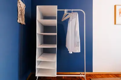 a closet with a white shirt hanging on a rack at Indigo Spirit with Terrace & Foosball Old Town in Belgrade