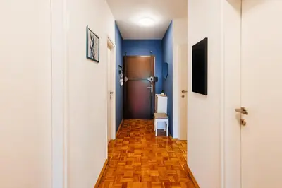 a hallway with blue walls and wooden floors and a refrigerator at Indigo Spirit with Terrace & Foosball Old Town in Belgrade