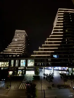 a large building at night with lights on at BW Maša in Belgrade