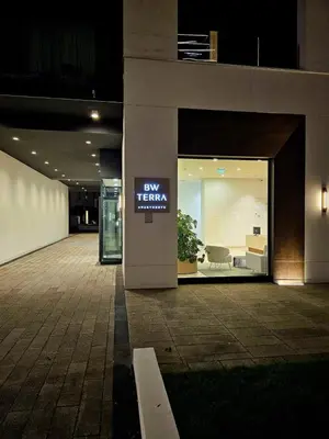 a lobby of a building with a pay team sign in the window at BW Maša in Belgrade