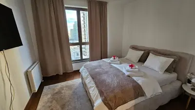 a bedroom with a bed with two towels on it at BW Ivona Apartment Beograd na vodi in Belgrade