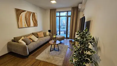 a living room with a couch and a table at BW Ivona Apartment Beograd na vodi in Belgrade