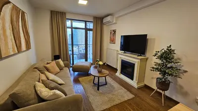 a living room with a couch and a fireplace at BW Ivona Apartment Beograd na vodi in Belgrade
