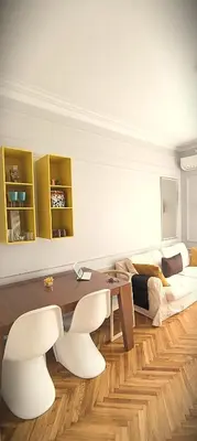 a living room with a table and white chairs at Apartment JADesign Vračar, Belgrade in Belgrade
