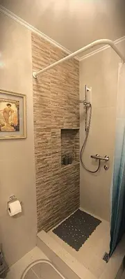 a bathroom with a shower with a glass door at Apartment JADesign Vračar, Belgrade in Belgrade