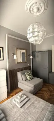 a bedroom with two beds and a chandelier at Apartment JADesign Vračar, Belgrade in Belgrade