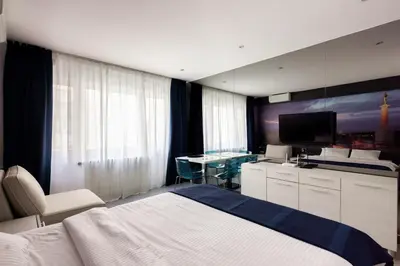 a bedroom with a bed and a tv and a desk at Square 19 in Belgrade