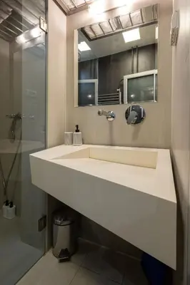 a bathroom with a white sink and a shower at Square 19 in Belgrade