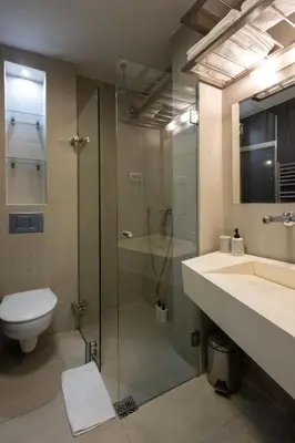 a bathroom with a shower and a toilet and a sink at Square 19 in Belgrade