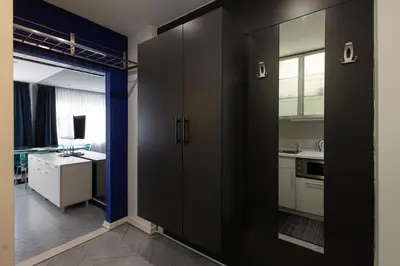 a kitchen with black doors and a kitchen with a sink at Square 19 in Belgrade