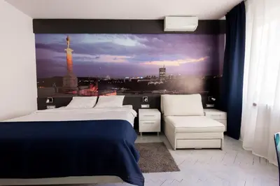 a bedroom with a bed and a view of a city at Square 19 in Belgrade