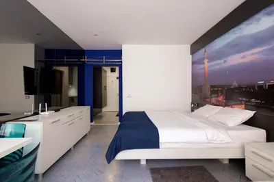 a bedroom with a large bed and a television at Square 19 in Belgrade