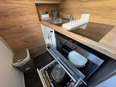 a small kitchen with a sink and a stove at Anywhere on Foot - FREE Parking in Belgrade