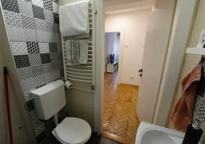 a small bathroom with a toilet and a sink at Anywhere on Foot - FREE Parking in Belgrade