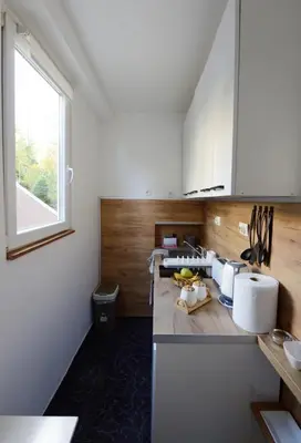 a kitchen with white cabinets and a window at Anywhere on Foot - FREE Parking in Belgrade
